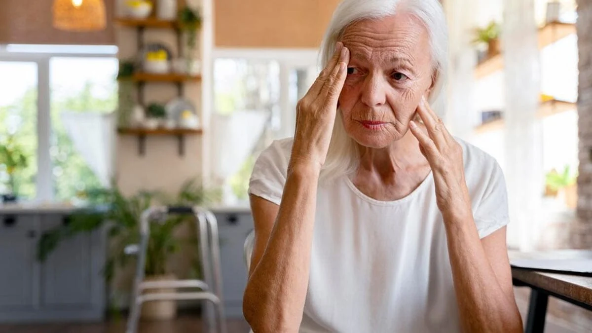 Grandmother with Alzheimer's sitting thoughtfully, highlighting concerns about aluminum and Alzheimer's.