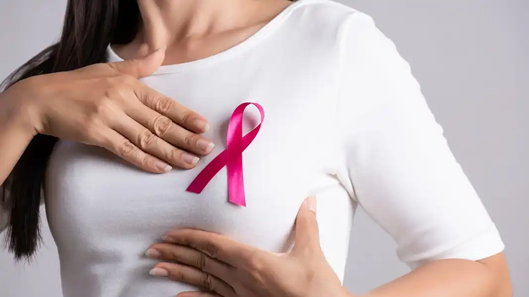 Woman wearing a breast cancer awareness symbol, highlighting concerns about aluminum and breast cancer