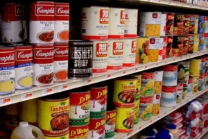 Aluminum cans of food on a supermarket shelf, highlighting aluminum packaging in food products